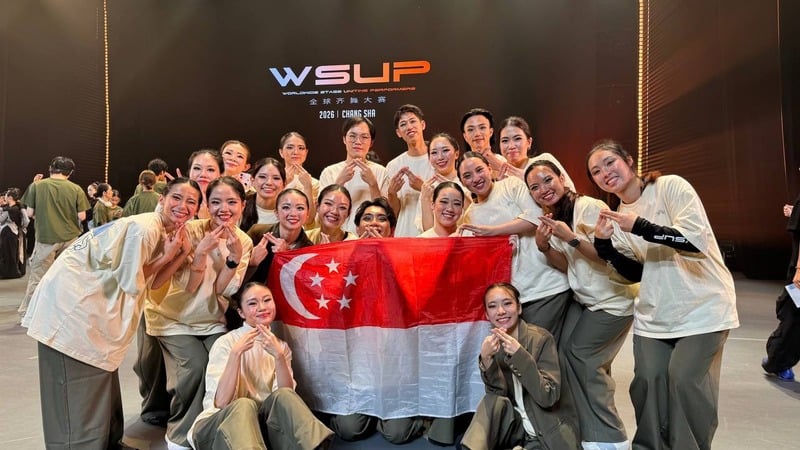 The STEP team holding the Singapore flag at the WSUP World Finals