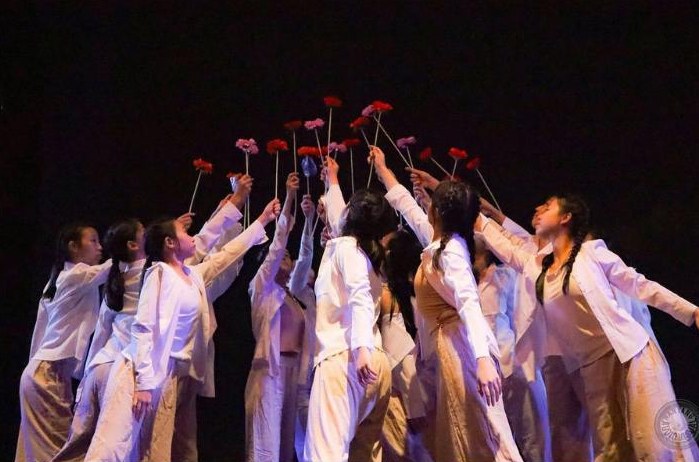School modern dance students performing on stage